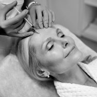 a close up of a woman brushing her teeth